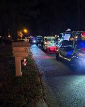 A group of cars on a road with lights

Description automatically generated